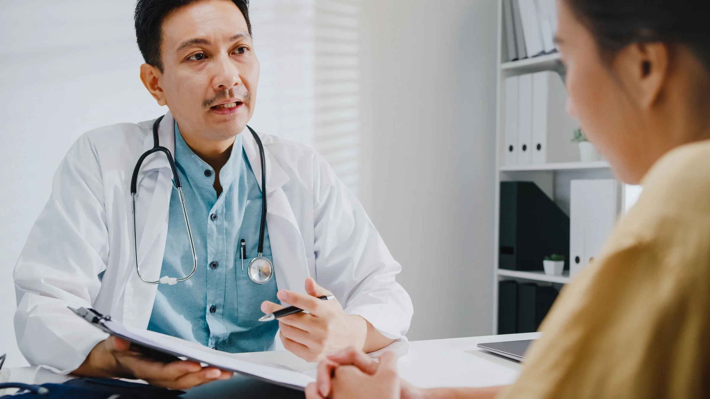 A doctor explaining a procedure to a patient.