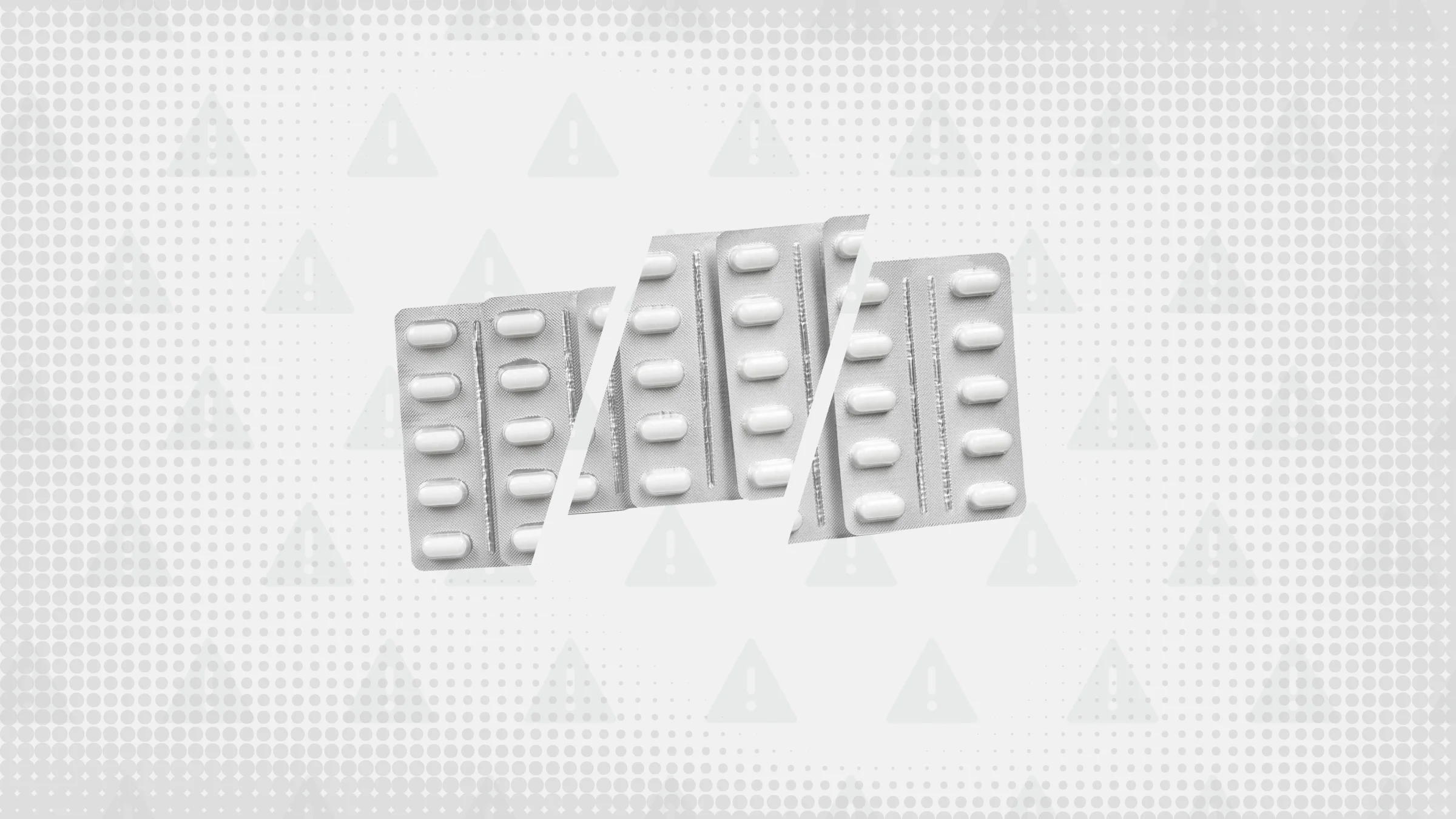 Gray background with texture and warning sign pattern. In the center are three silver blister packs of oblong white pills cut into thirds. 