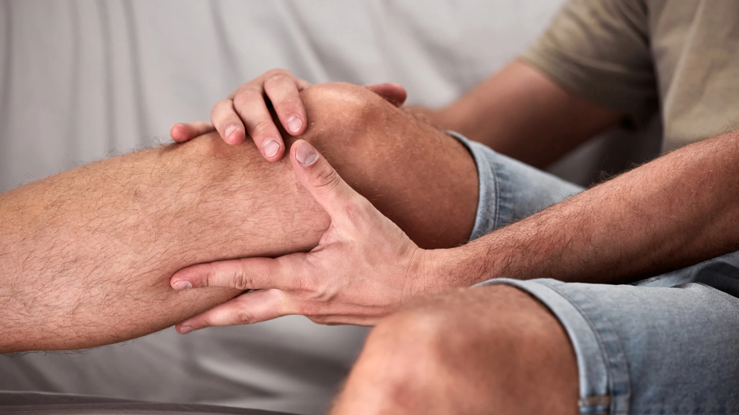 Cropped shot of someone holding their knee in pain.