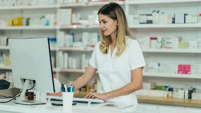 Pharmacists: digital pharmacy accreditation: pharmacist using computer 1355434696