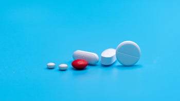 medication basics: pills on blue background 1310855034