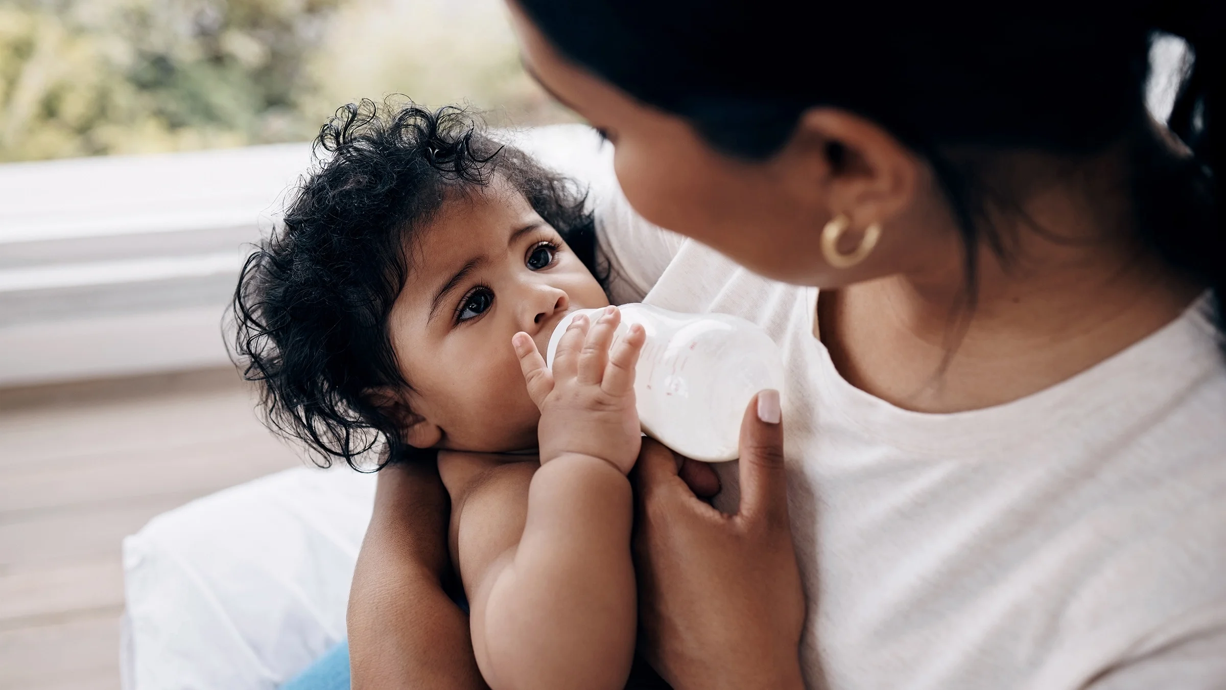 A woman bottle feeds her baby.