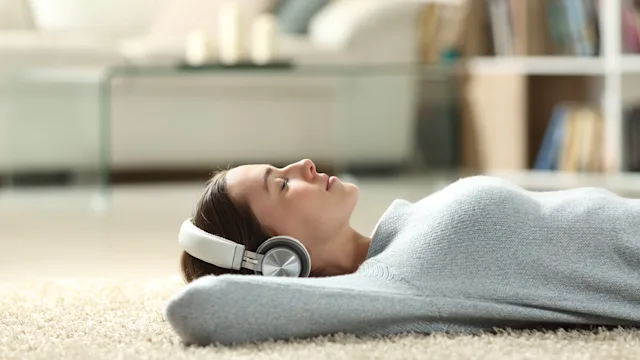Health: neurological: woman-laying-down-with-headphones-on-1294500868