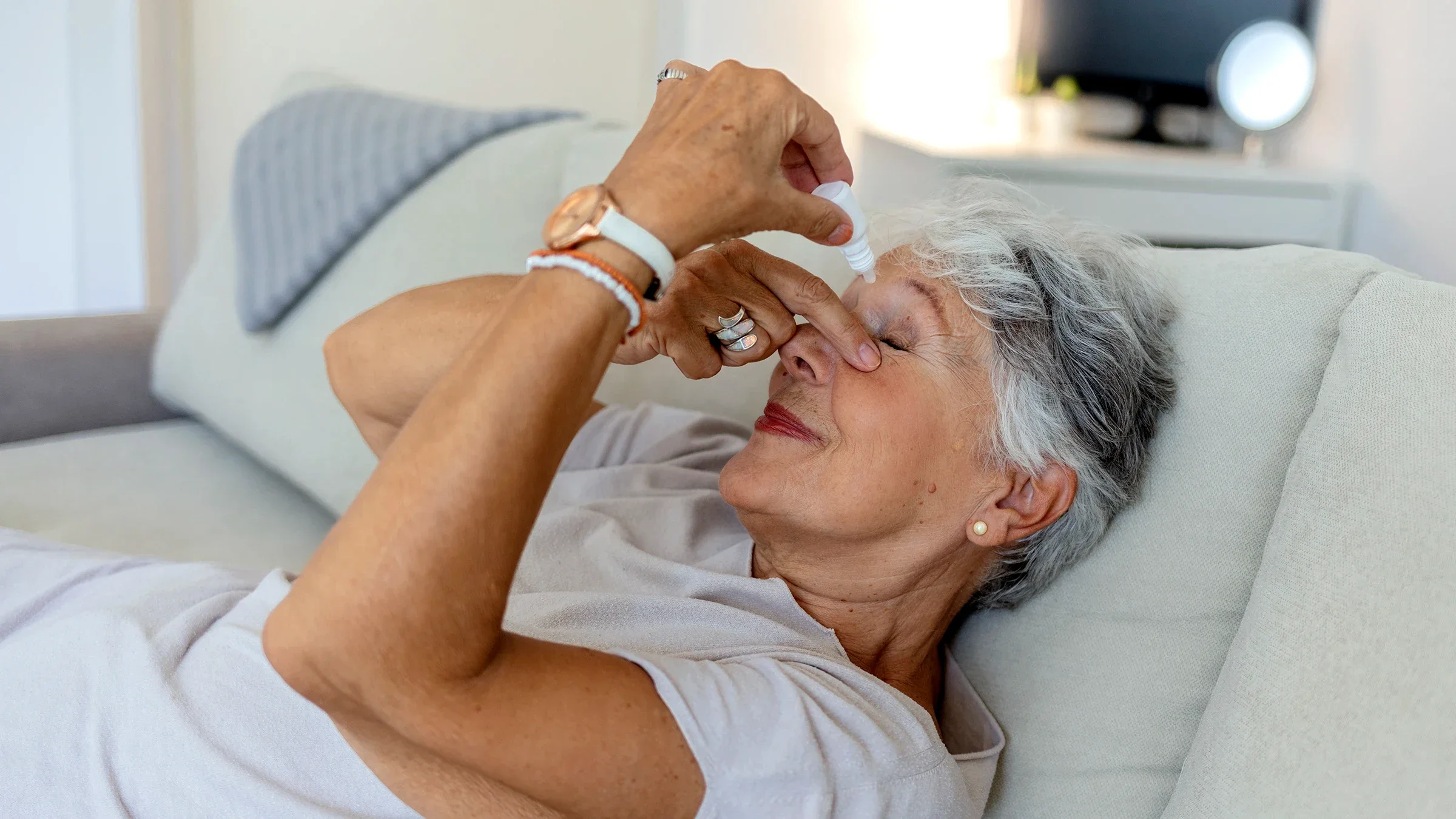 A woman uses eye drops at home.
Jelena Stanojkovic/iStock via Getty Images Plus