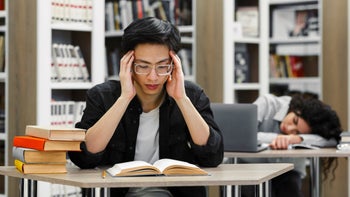 Substance use disorder: Perfectionism: tired late-night studying college library 1252691219