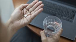 A woman holds pills in the palm of her hand.
Anderson Coelho/E+ via Getty Images