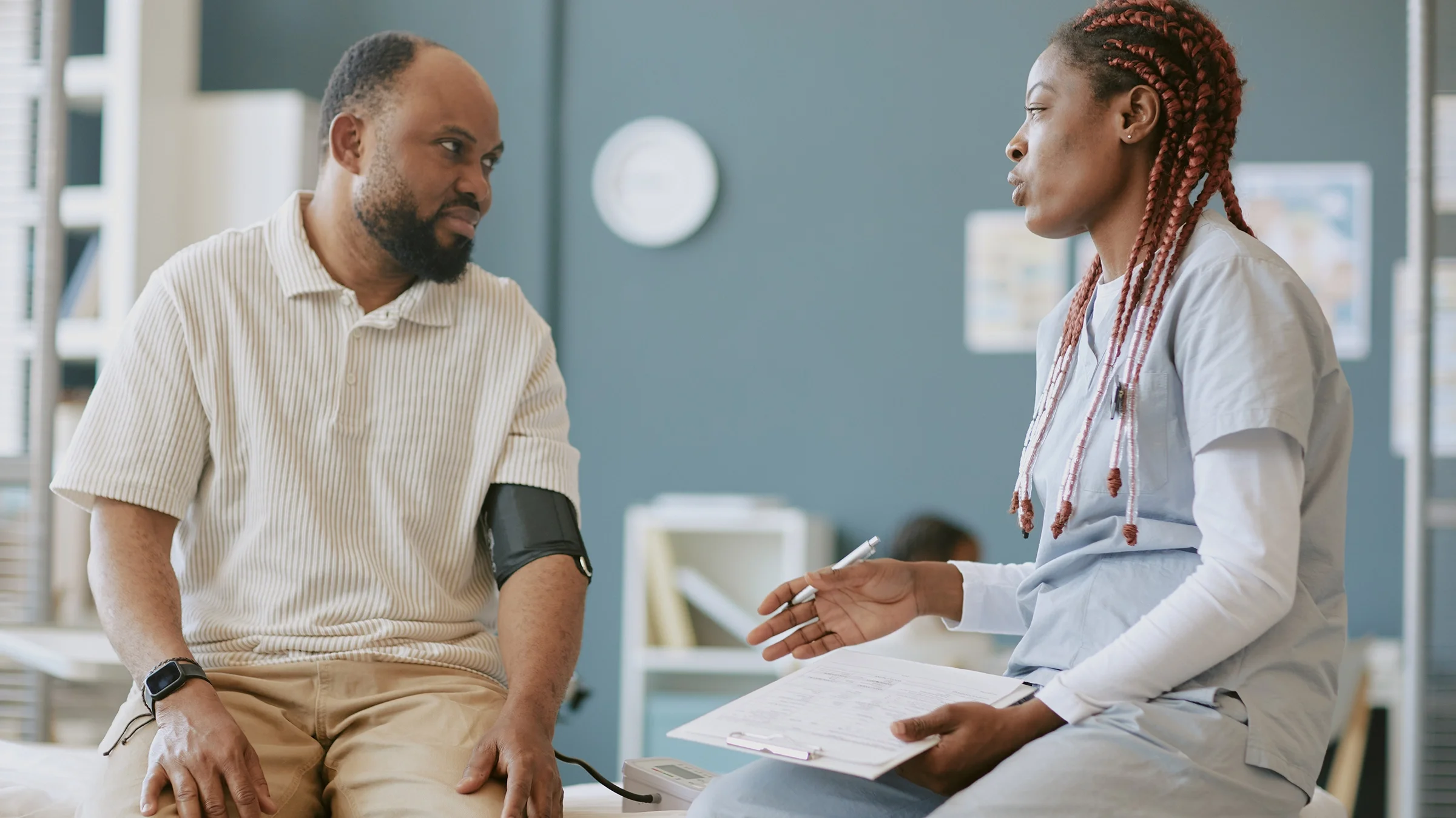 A man talks with a healthcare professional during a medical appointment.