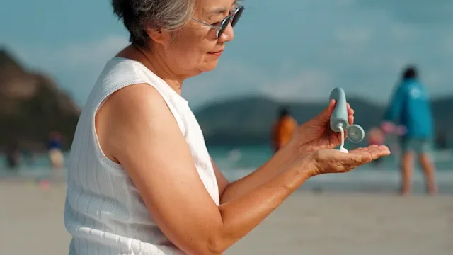 Dermatology: woman applying sunscreen 2279440629