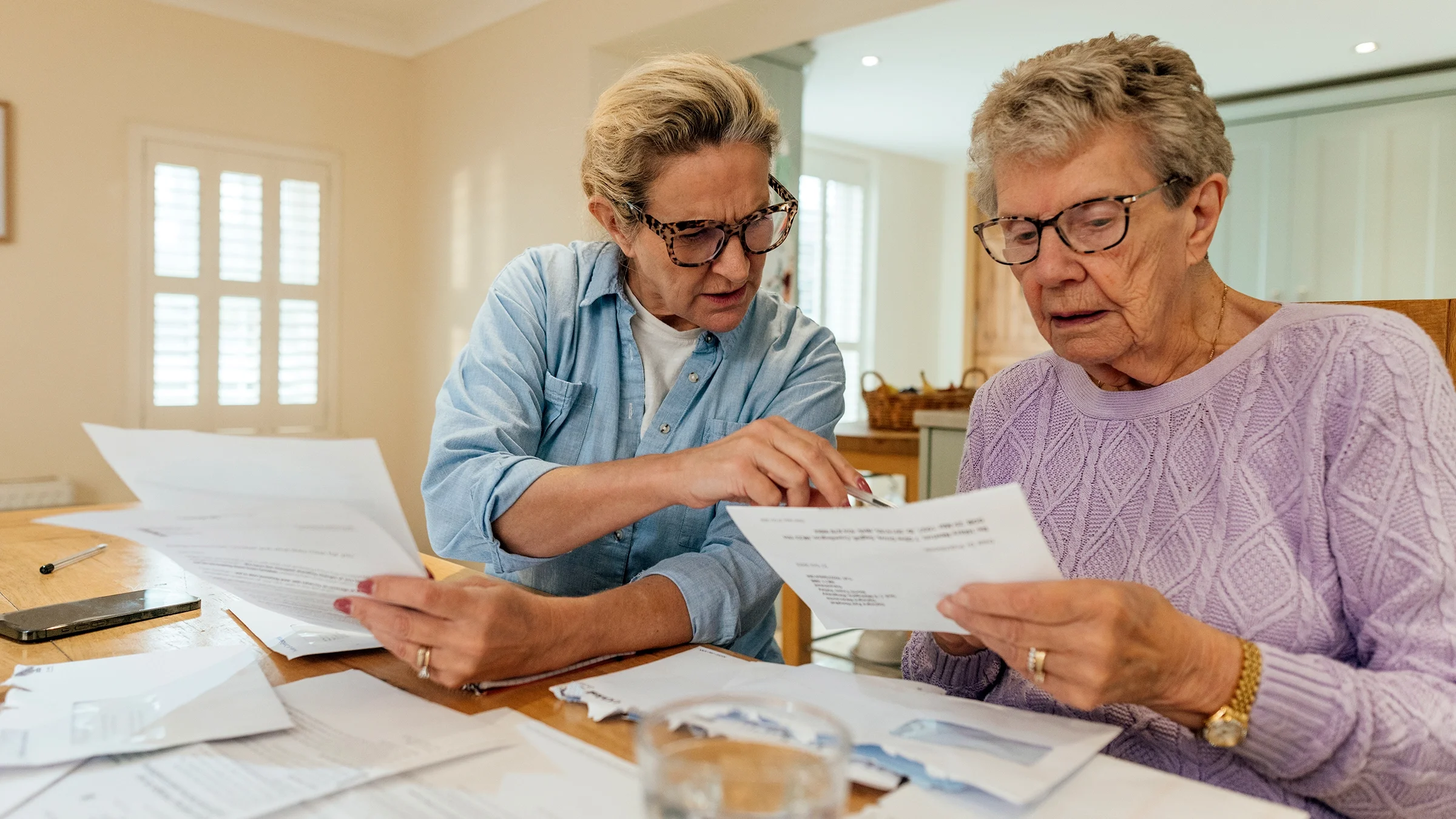 Adult woman and daughter navigating through expenses