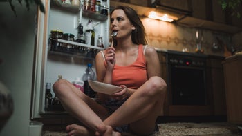Health: Cannabis: woman eating midnight snack GettyImages-1127910459