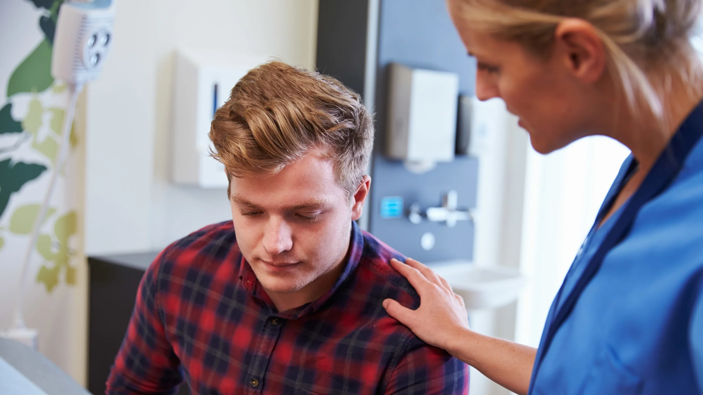A patient being comforted by a nurse.