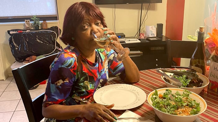 Xenia Goldson, seated at a table with a salad.