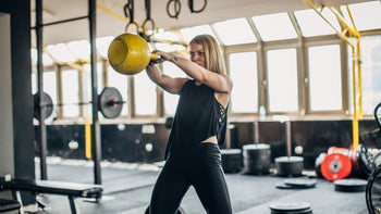 Health: Movement and exercise: woman doing kettleball exercise-1239246233