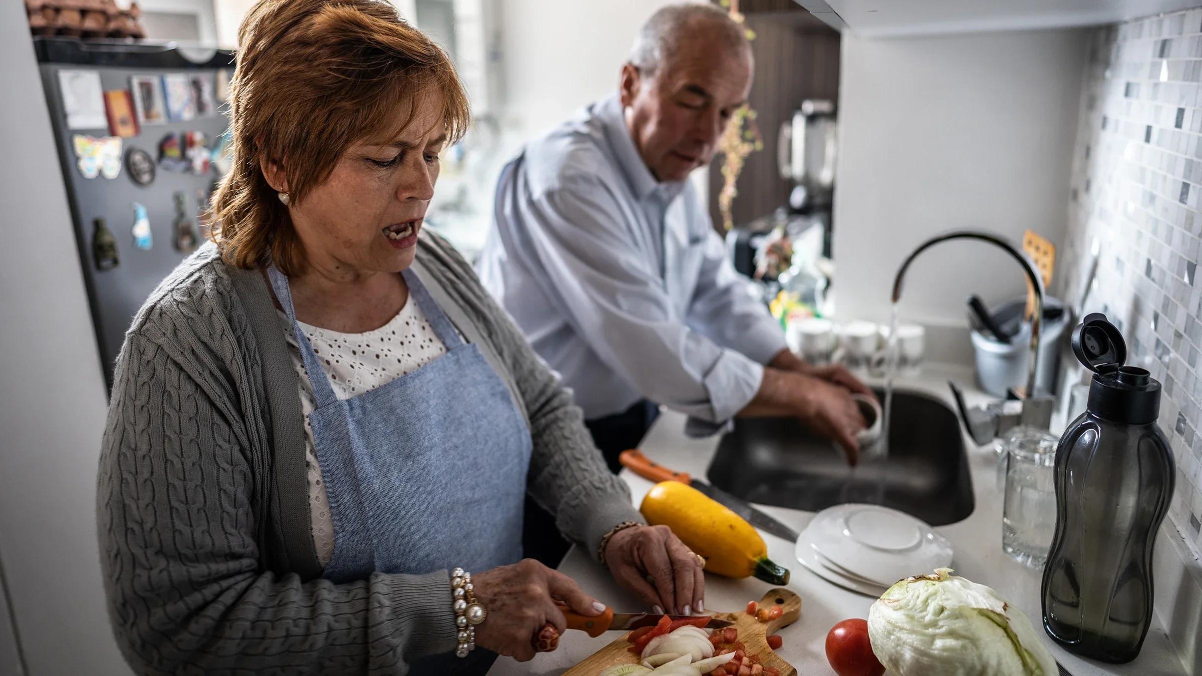 A couple prepare a meal in the kitchen. 
Frazao Studio Latino/E+ via Getty Images