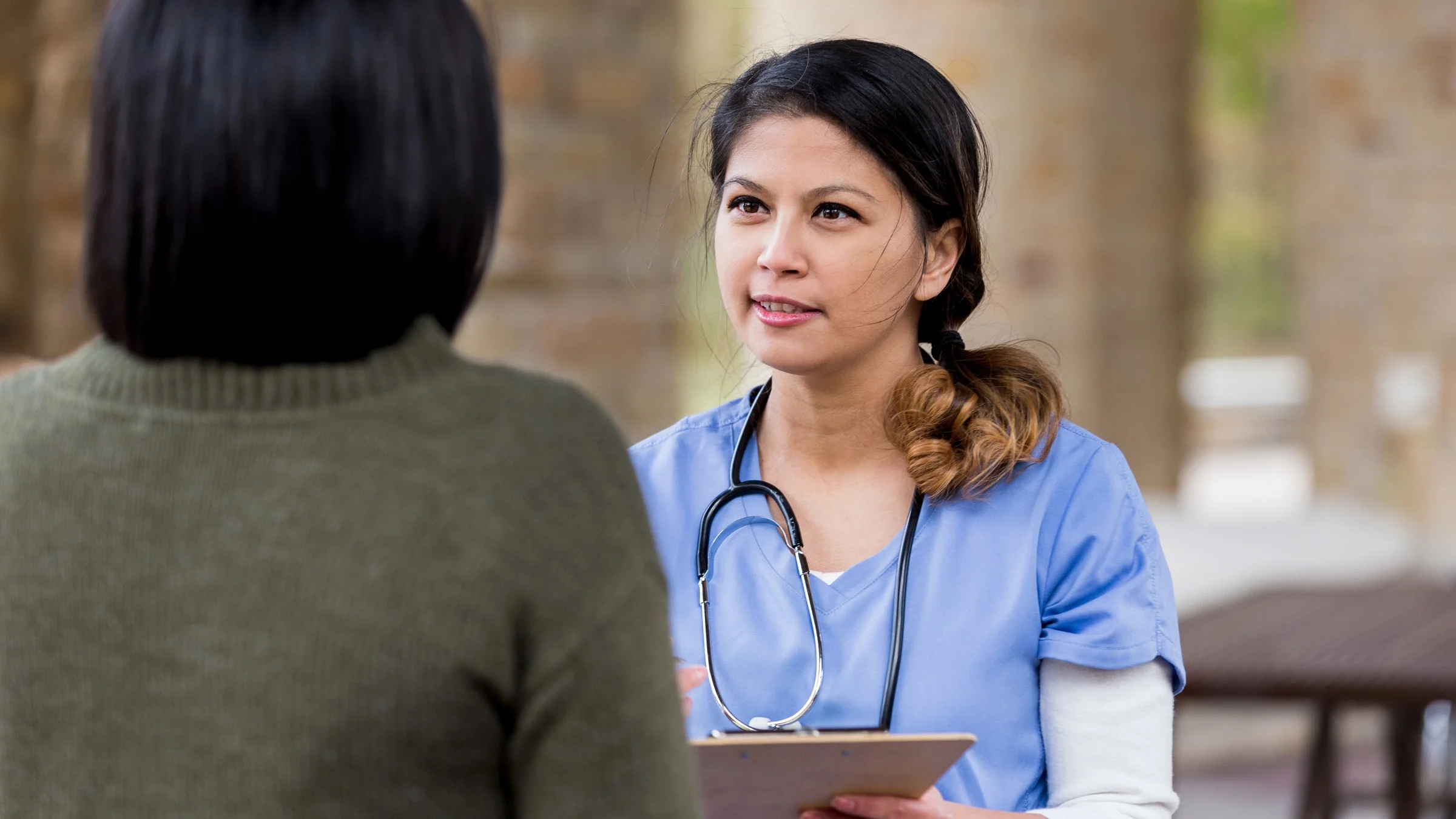 A healthcare professional talking to a patient. 