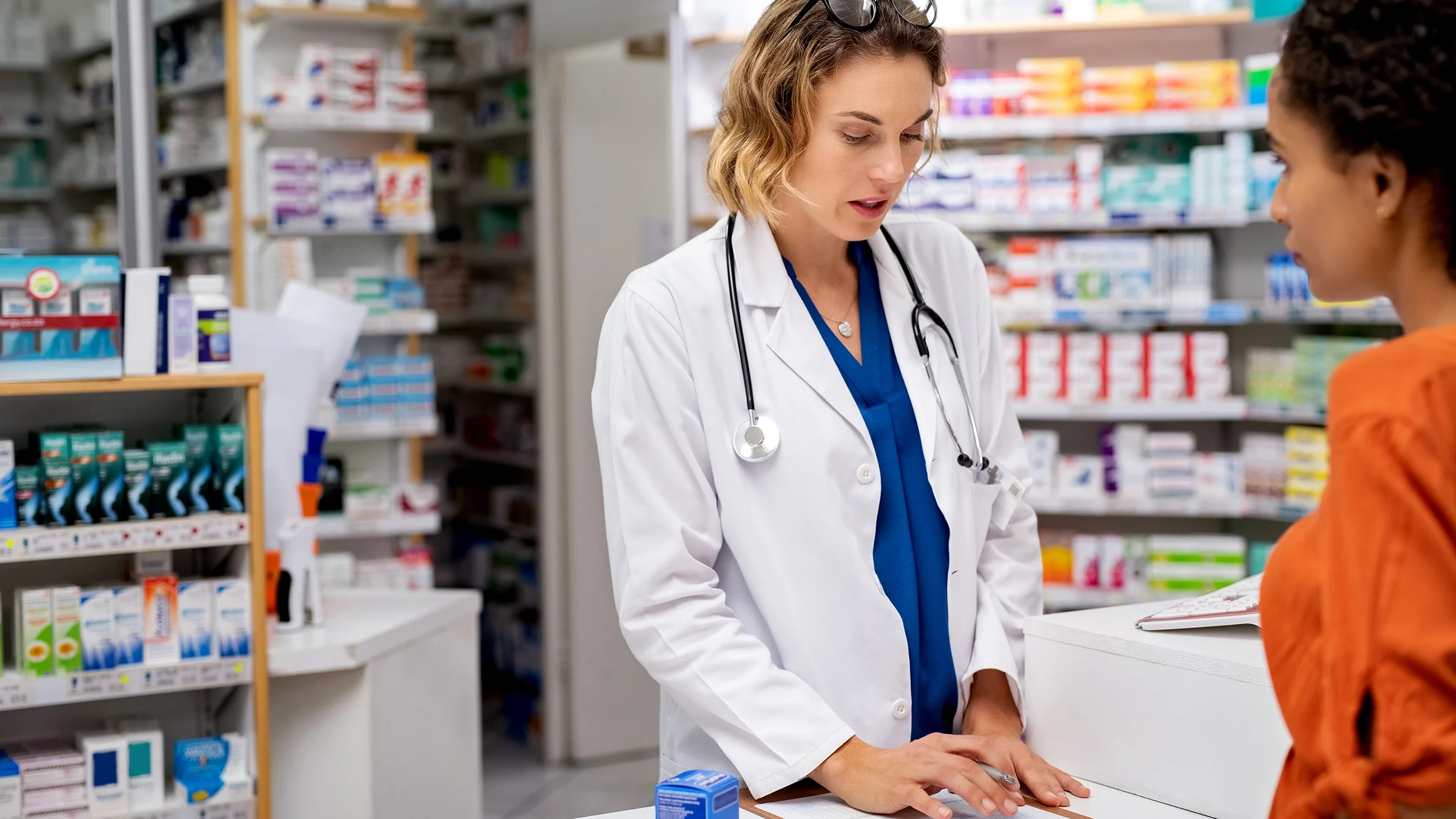 A pharmacist speaks to a customer.