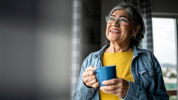 diet-nutrition: senior woman drinking from a mug 2163495303