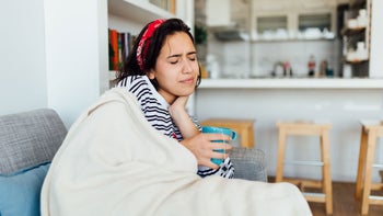 Health: Covid-19: woman sore throat 1283226144