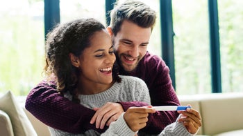 Fertility: smiling couple with pregnancy test 942878394