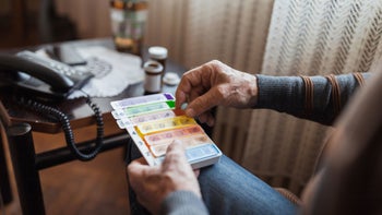 Health: Meclizine: close up man with pill organizer 1388819968