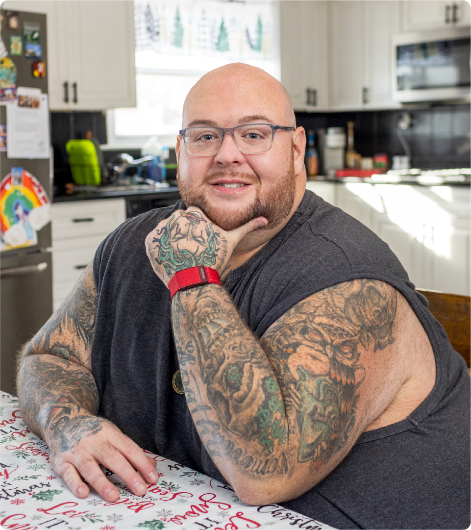 Pete Brennan is pictured sitting in his kitchen.