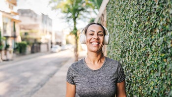 Dental-care: portrait of woman smiling wearing wireless headphones 1988230433