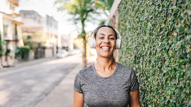 Dental-care: portrait of woman smiling wearing wireless headphones 1988230433