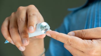 Pharmacy: closeup hands applying ointment 2174074831