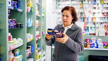 Kidneys: senior woman shopping at pharmacy 1906853460