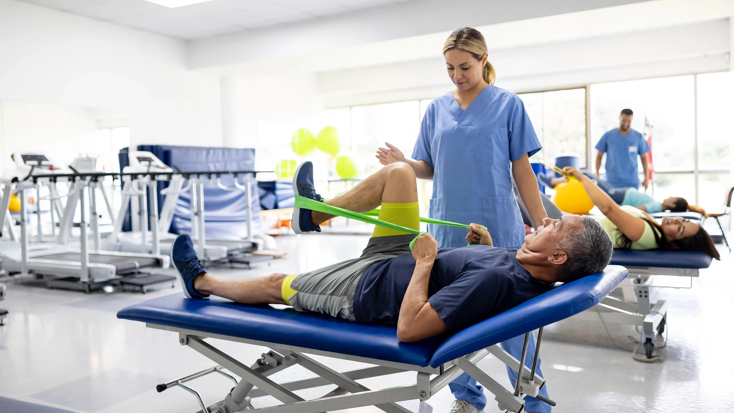 Man doing physical therapy exercises using a resistance band.