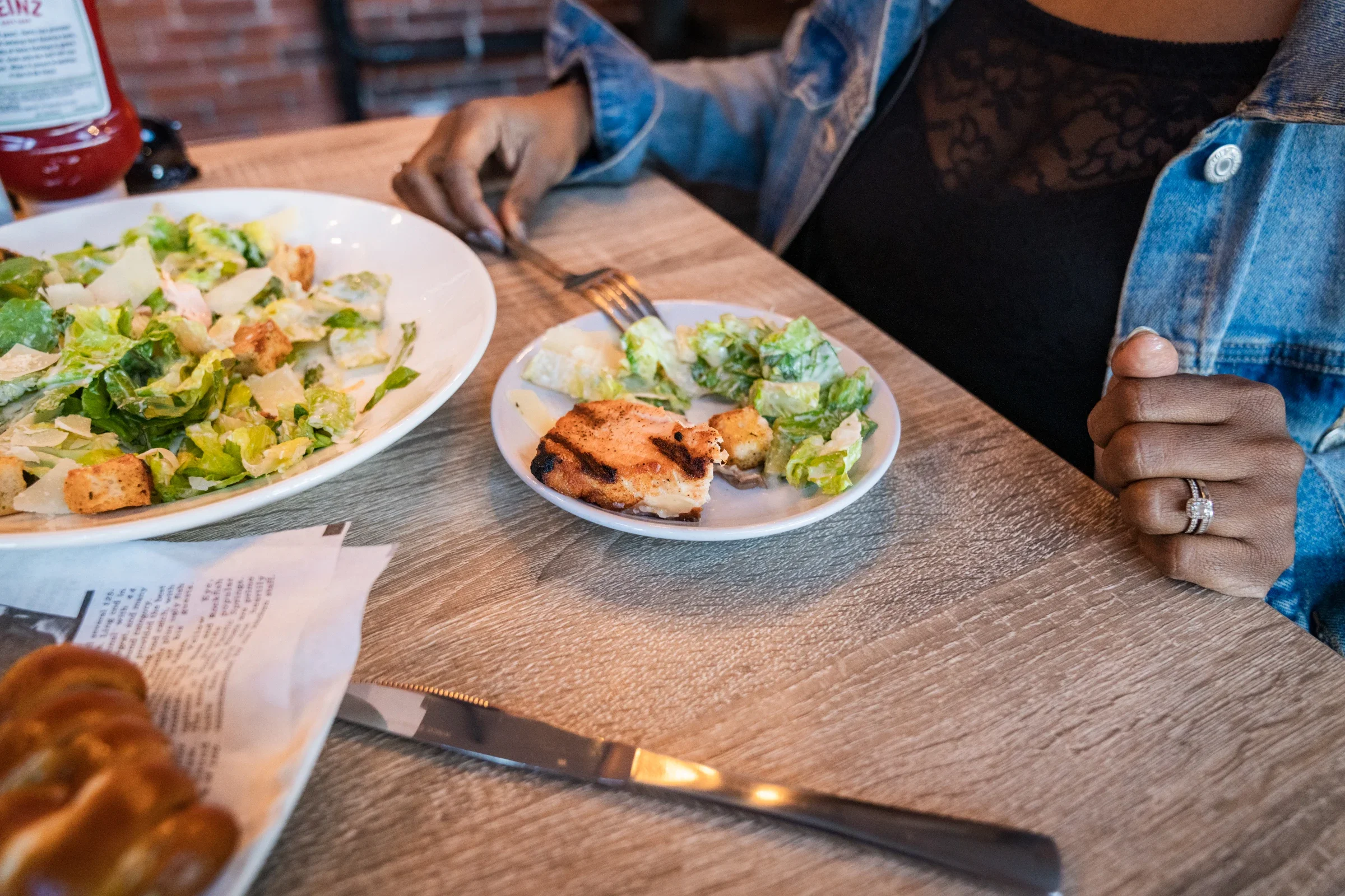 Closeup of Arelis Latorella splitting a meal while out with her husband. 