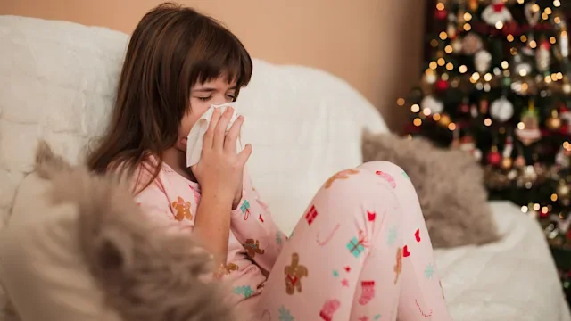 Flu: young girl sick on couch holidays 1361333451