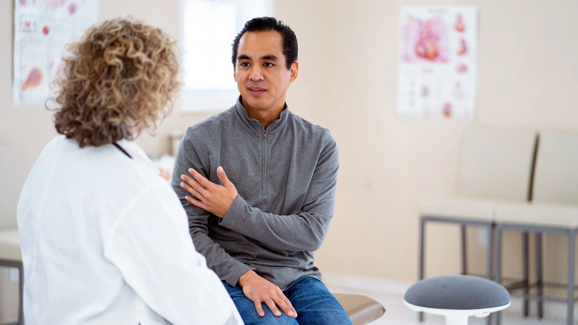 A man talks to a healthcare provider.