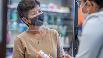 Health: Paxlovid: older woman talking to pharmacist 1362615426