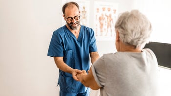 Health: Providers: older male nurse helping patient 1325012733