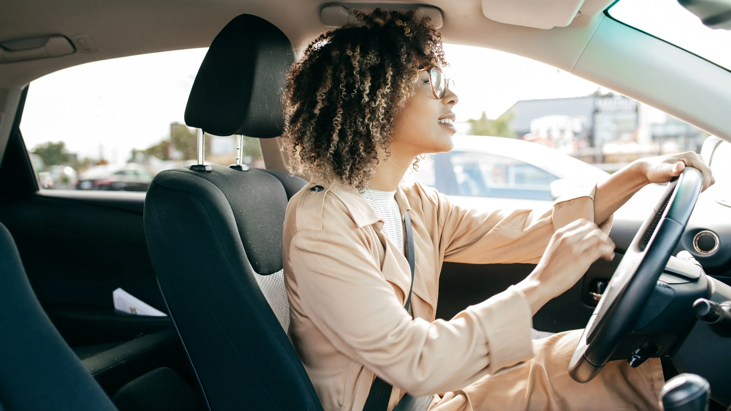 A young adult driving a car.