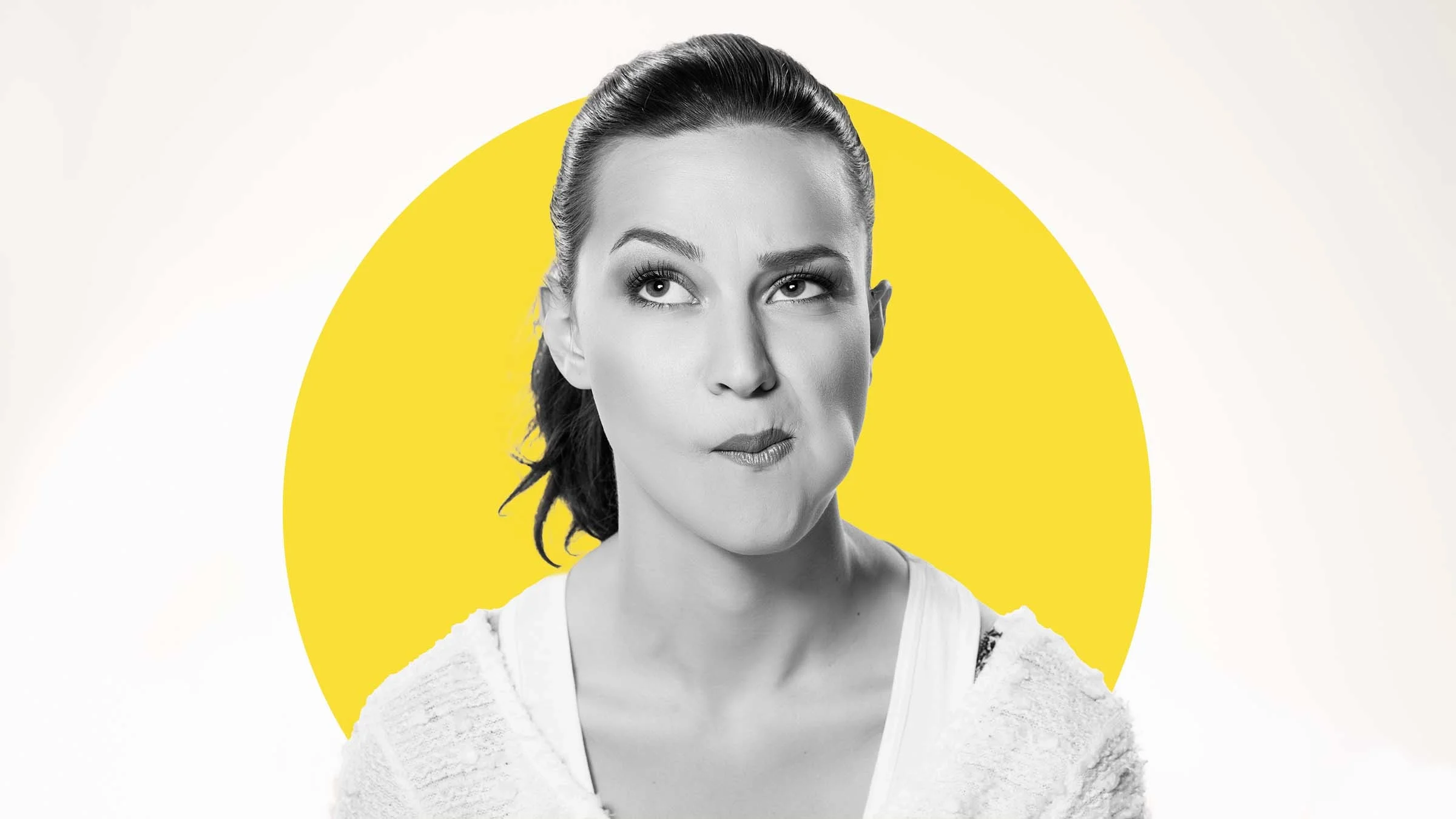 Black and white portrait of a woman on a plain white background. There is an added yellow graphic circle behind her head. It looks like she is moving her tongue along the inside of her mouth to do a self check of her teeth.