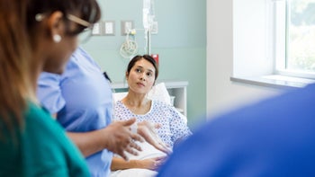 Pain: woman at hospital post surgery 1818651333