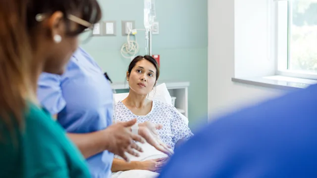 Pain: woman at hospital post surgery 1818651333