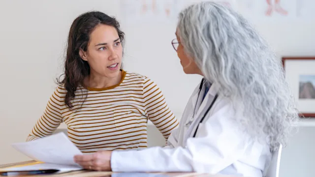 HCP: woman at a medical appointment 1296552093