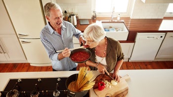 Senior health: Diet: senior couple cooking pasta 547127620