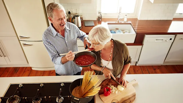Senior health: Diet: senior couple cooking pasta 547127620