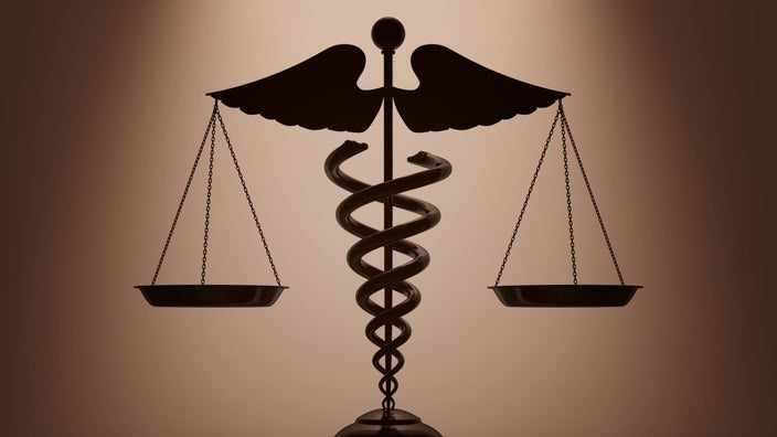 A 3D rendering depicts a caduceus and scales.