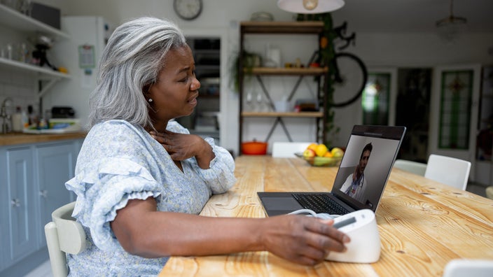 Woman at home talking to a doctor on a video call