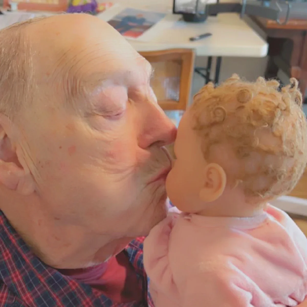 David Rothman is pictured kissing his lifelike therapy doll.