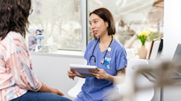 A healthcare professional speaks to a patient during a checkup.
SDI Productions/E+ via Getty Images 