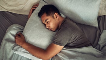 venlafaxine: man alone in bed and hugging a pillow 1332616385