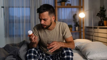 symbax: man reading Rx bottle 1739494453