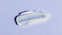 White cream smeared onto lavender background.
Yana Iskayeva/iStock via Getty Images Plus 