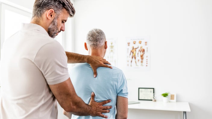 A patient receives a chiropractic back adjustment.